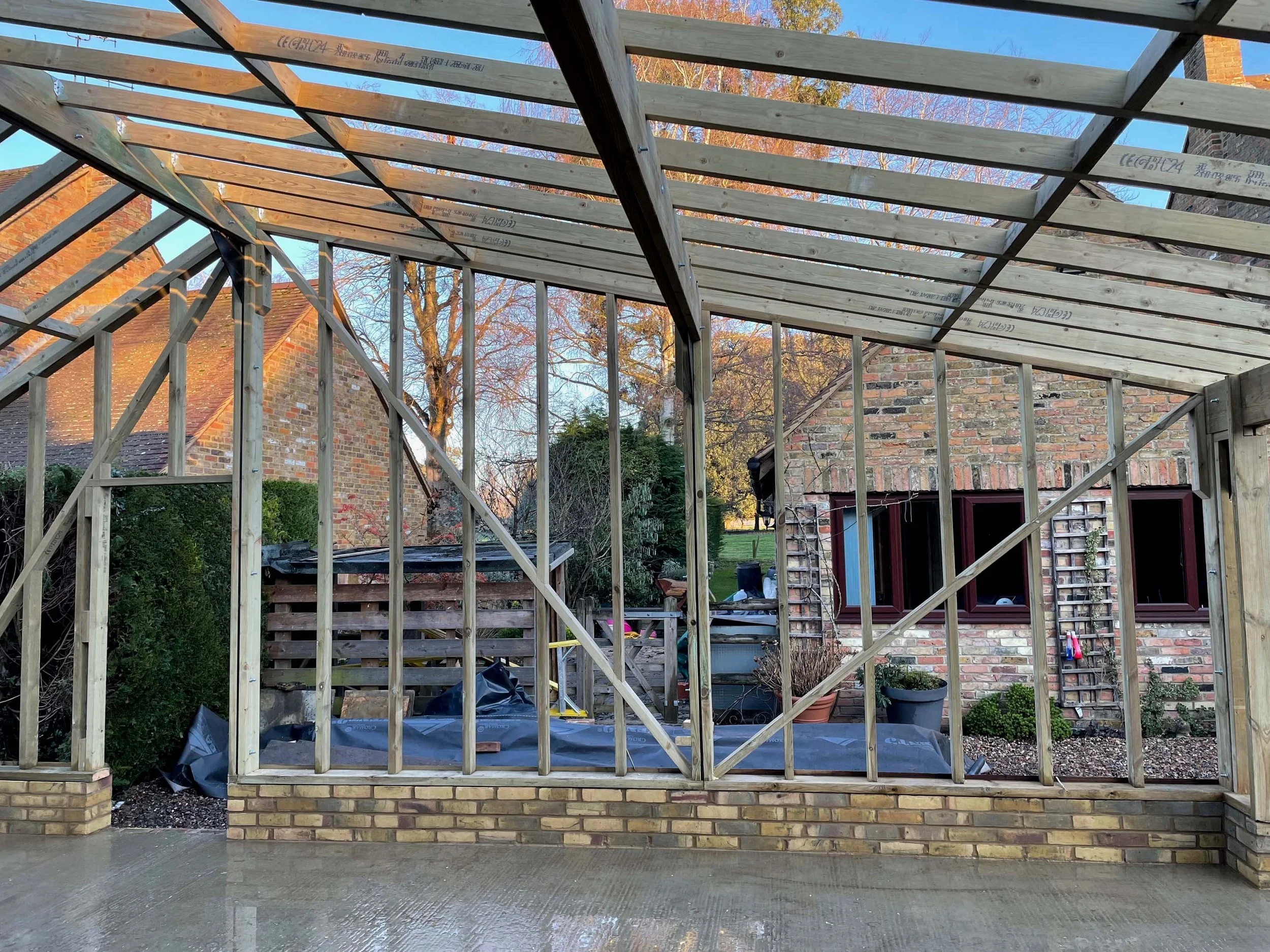 An image of wooden beams being installed for a car garage.