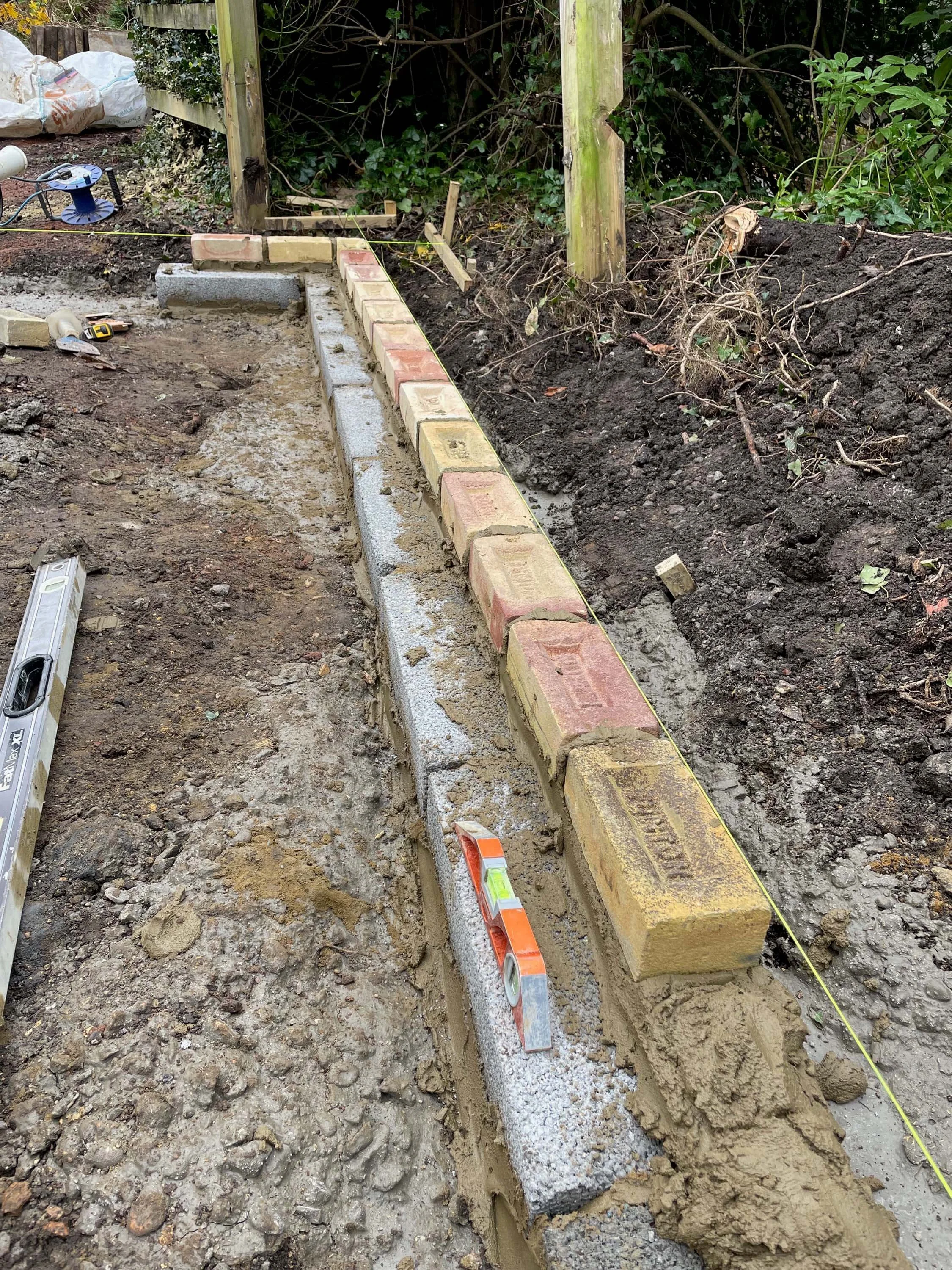 An image of laying bricks for building a car garage.
