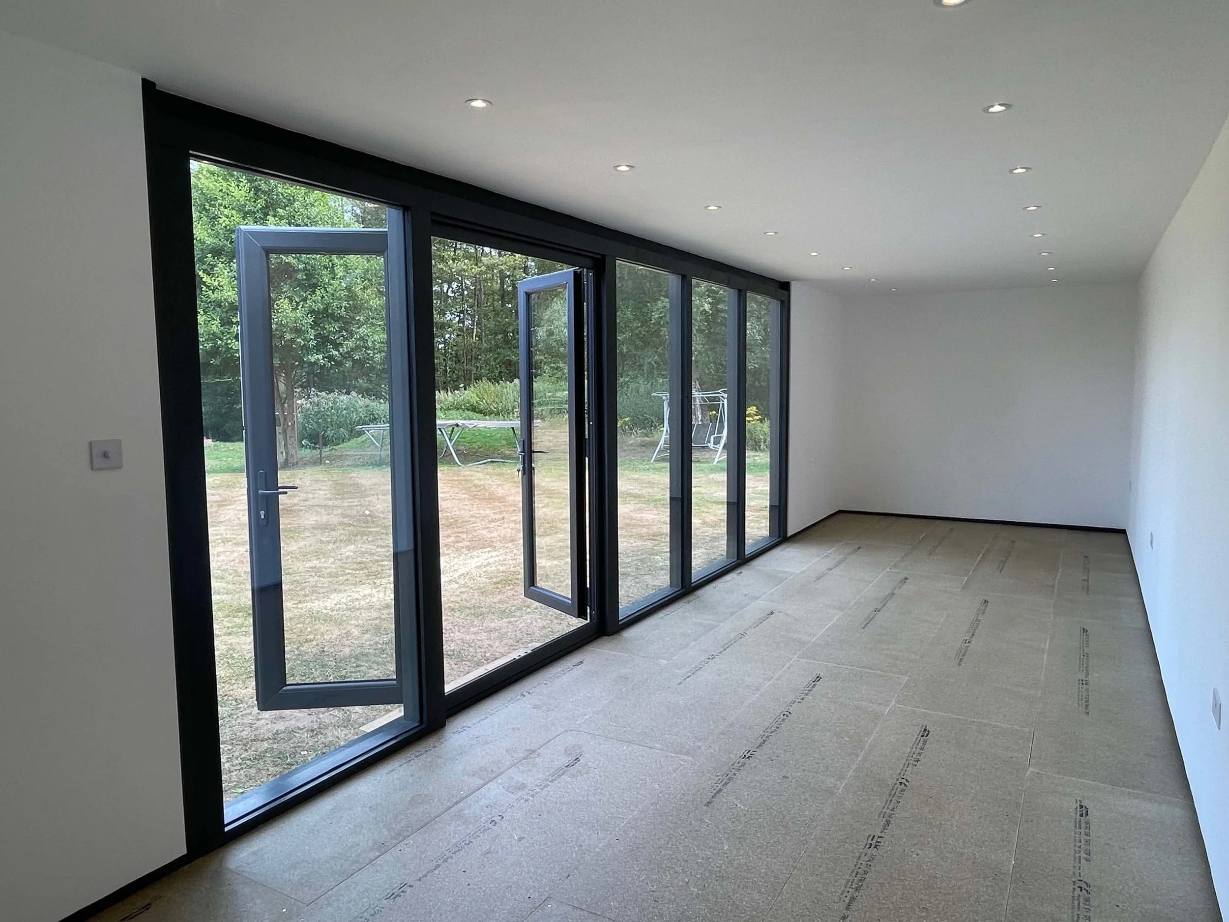 An image of glass doors to a summer house. 