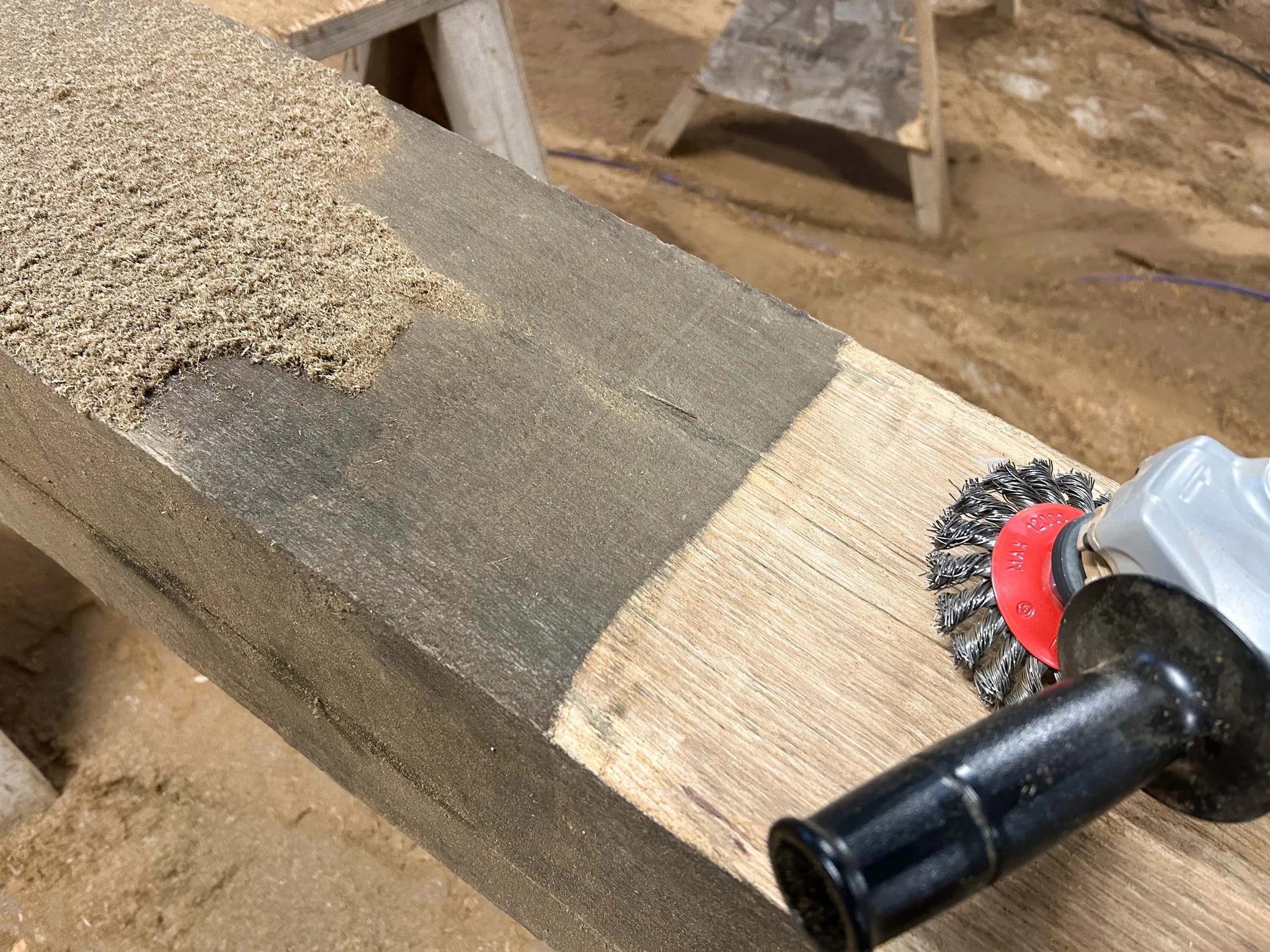 An image of an angle grinder cleaning oak beams.