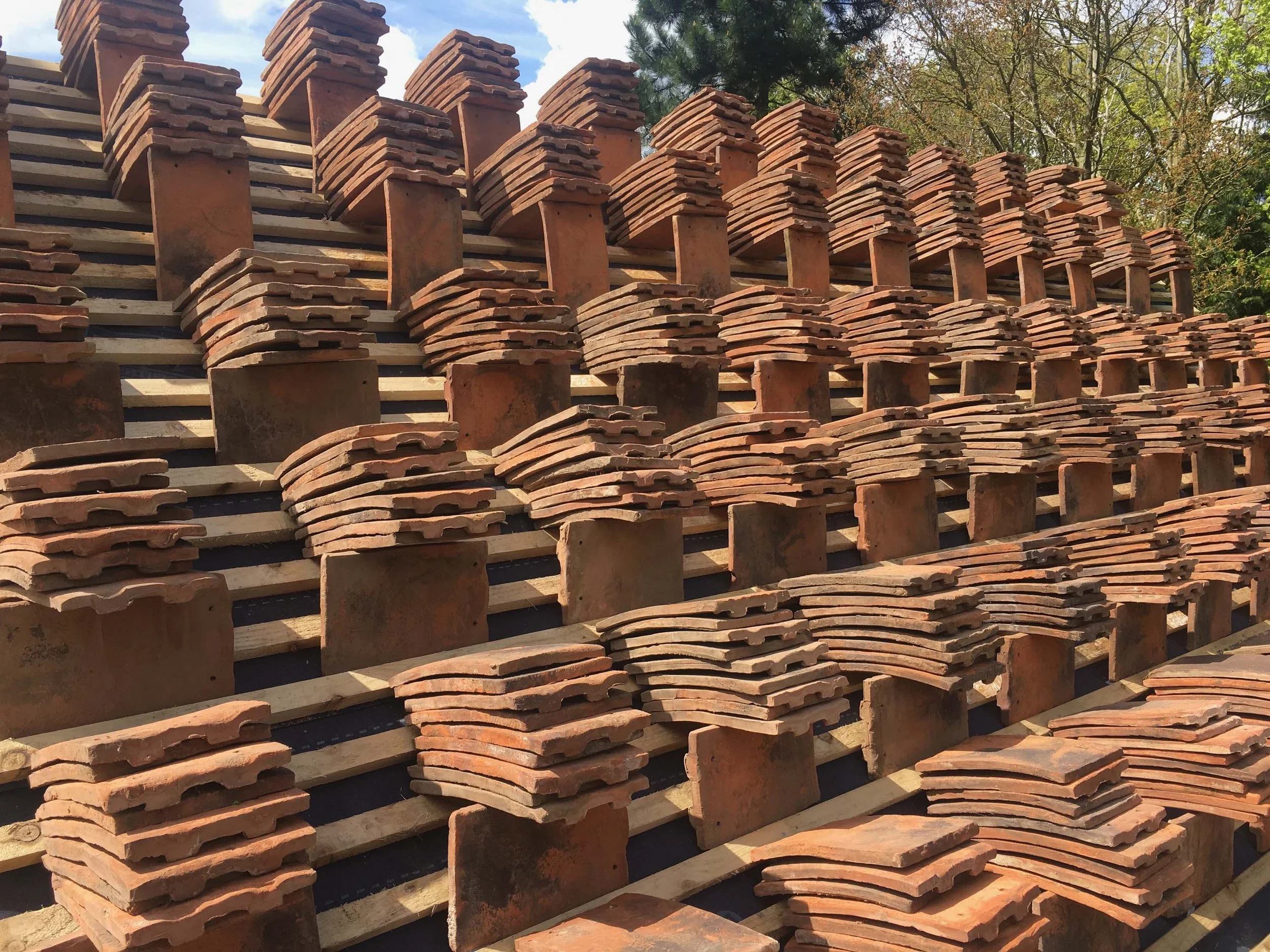 An image of tiles on the roof of an oak frame summer house barn