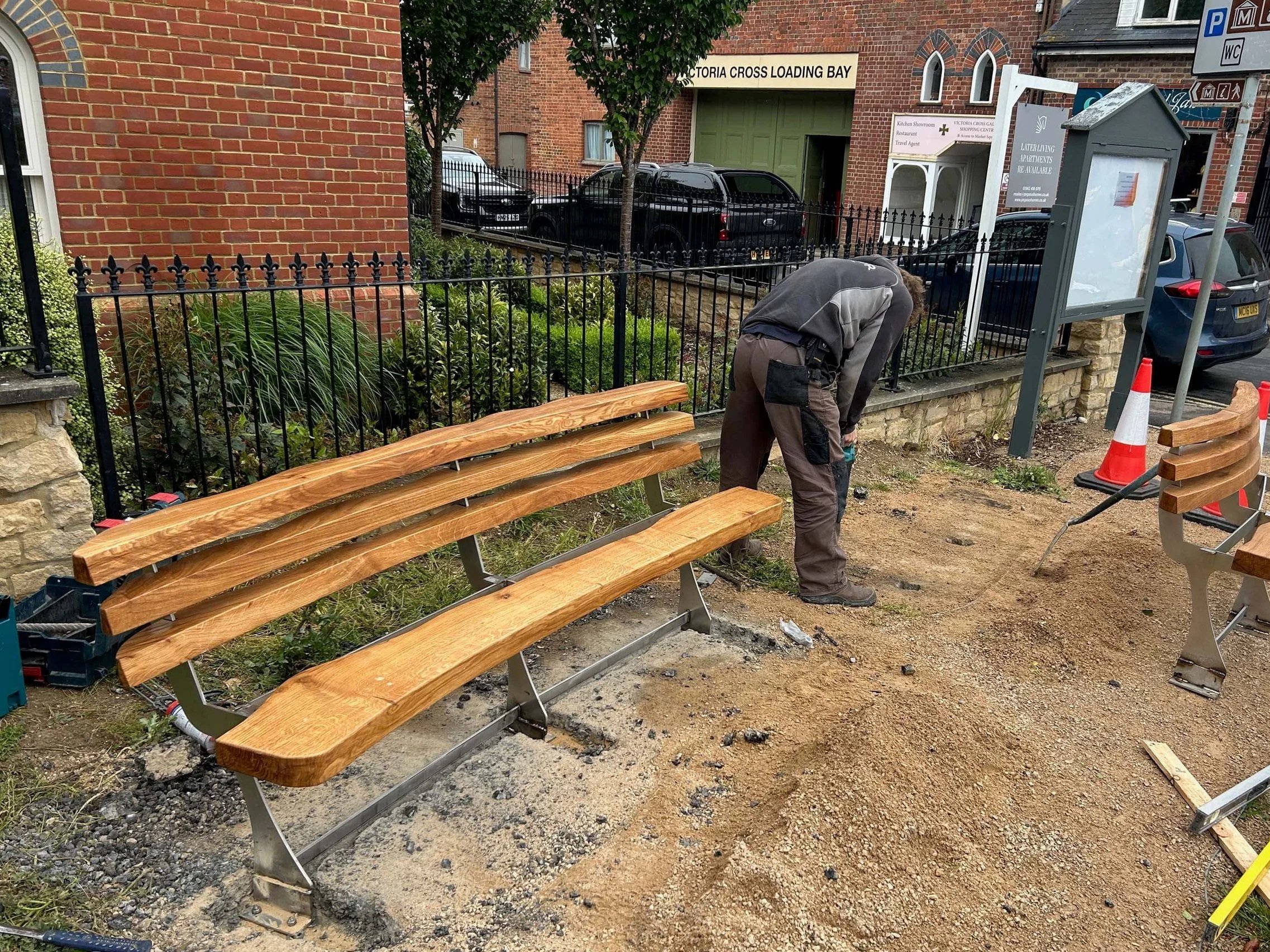 An image of a man installing an oak bench.