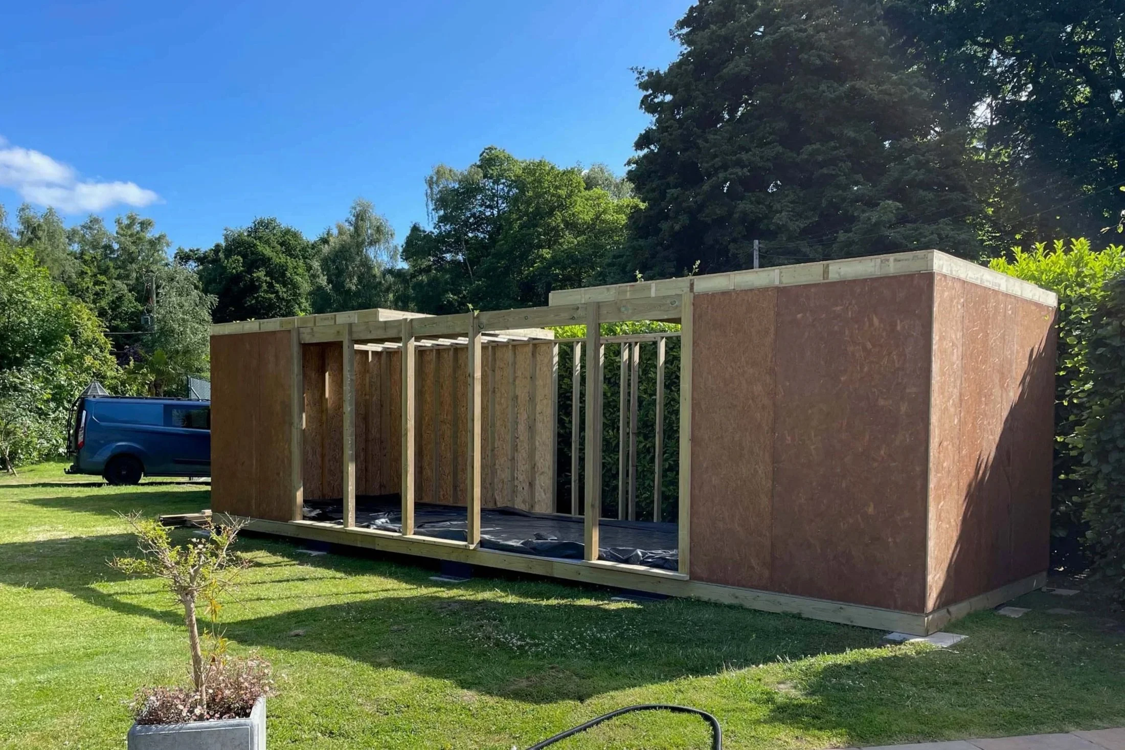 An image of a half finished structure of a summer house being built