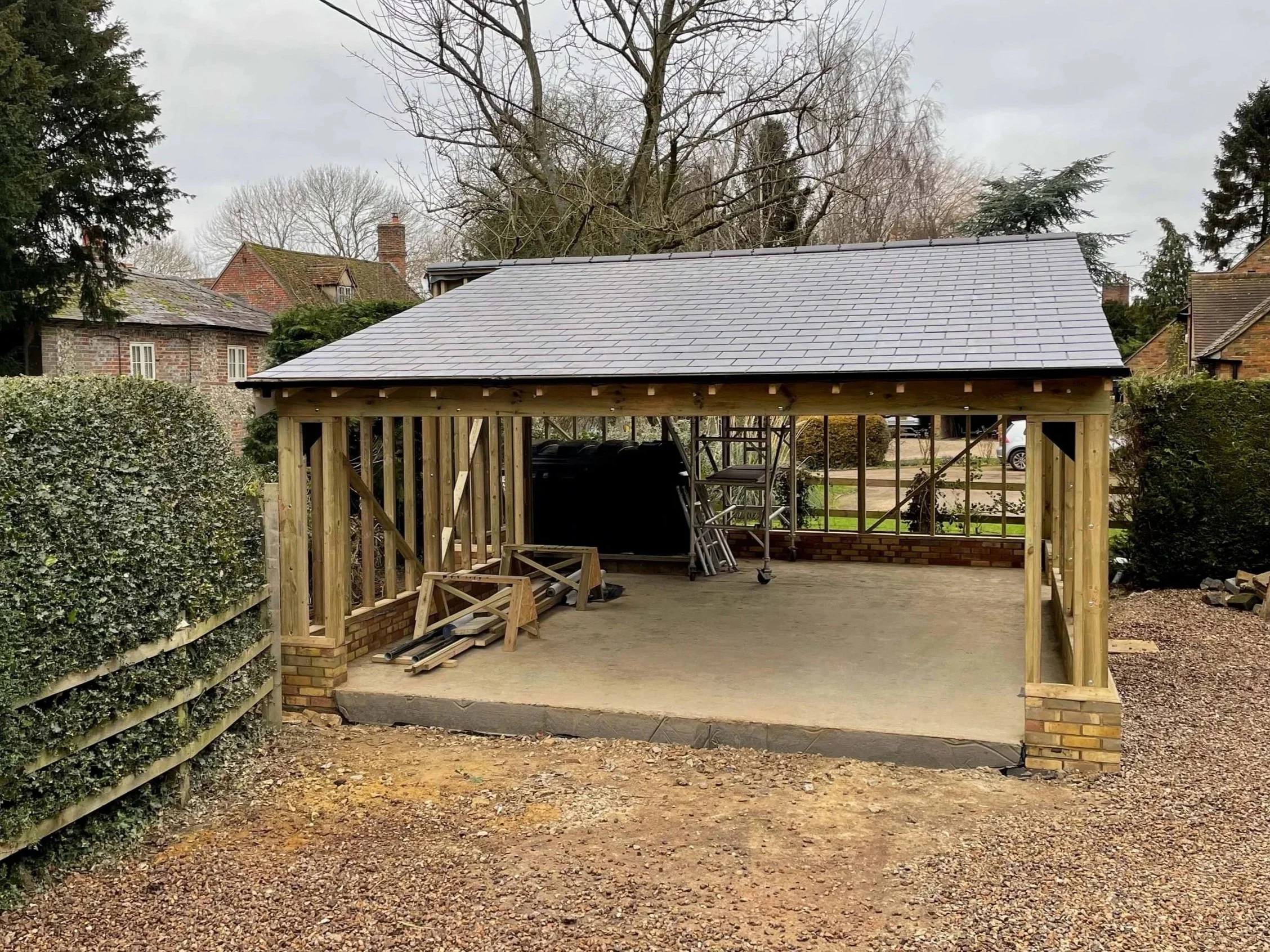 An image of a roof being put onto a timber frame garage