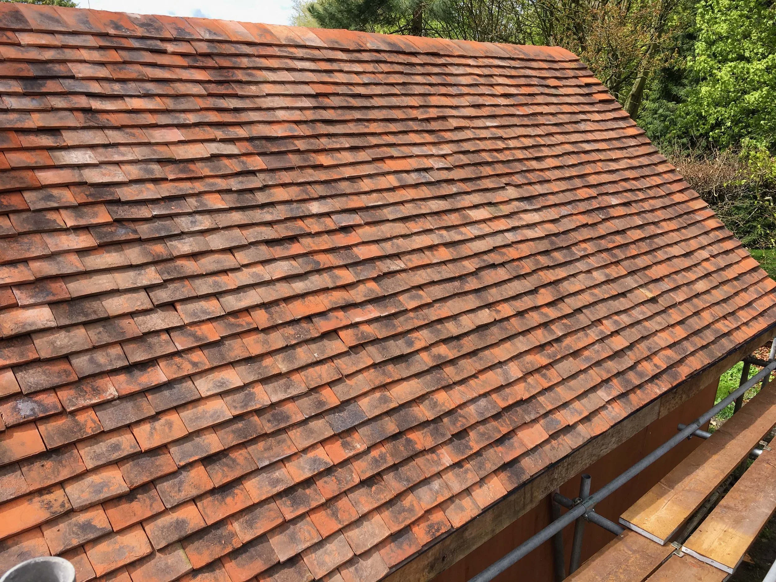 An image of a finished tiled roof of an oak frame barn summer house