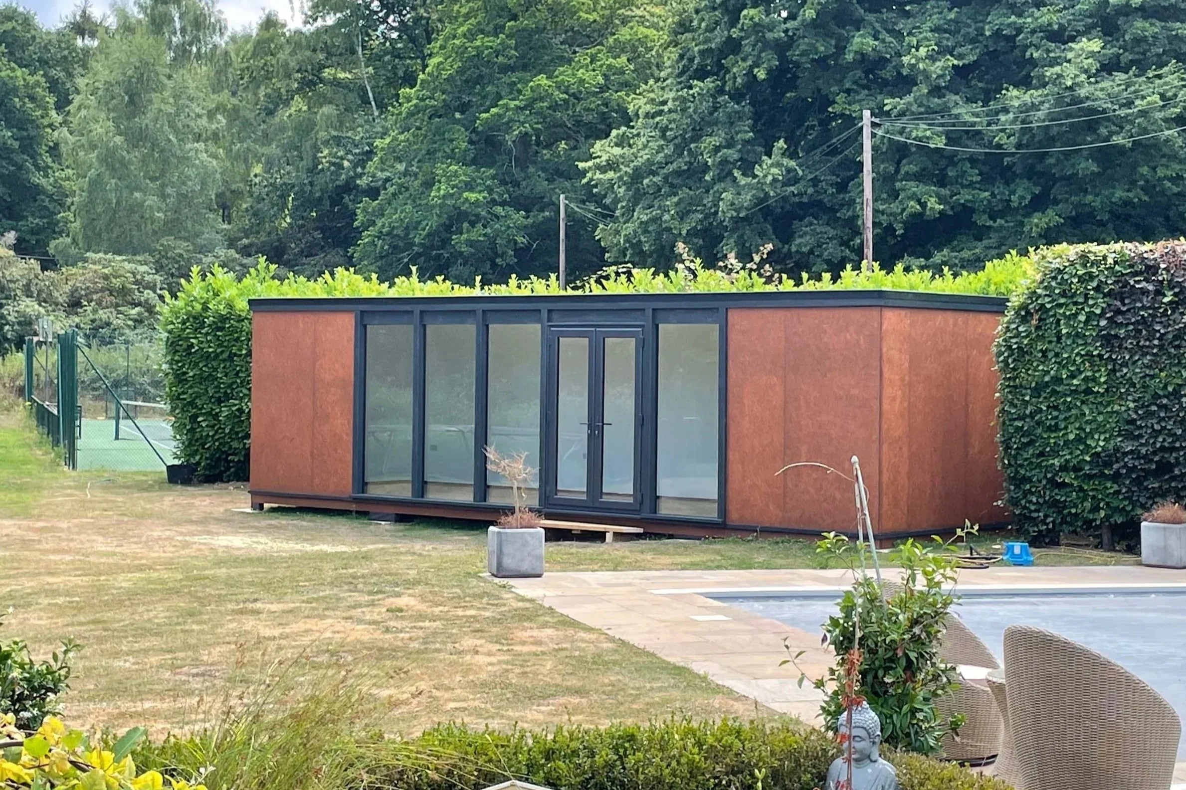 An image of summer house in a garden.