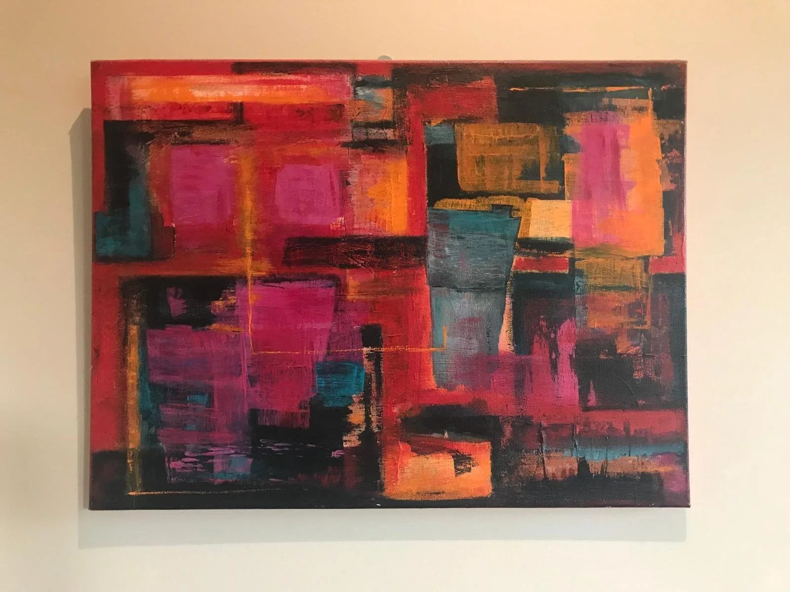 An abstract painting with bold strokes of red, pink, black, orange, blue, and yellow, depicting geometric shapes and textured layers.
