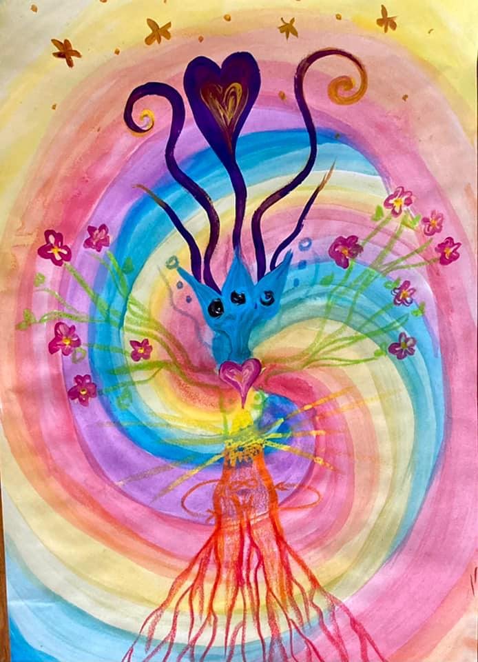 Colorful abstract painting of a blue cat's face with three eyes and heart-shaped nose, surrounded by a rainbow of swirling colors, flowers, and a radiant background.