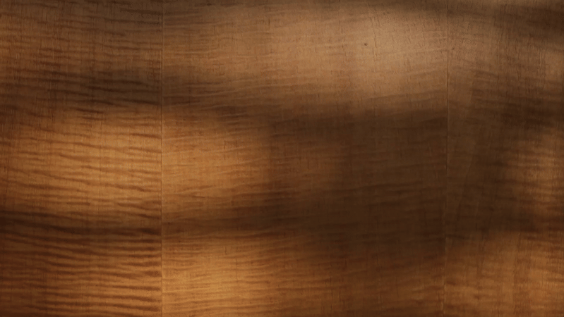 Close-up of a wooden surface with visible grain pattern and natural finish.