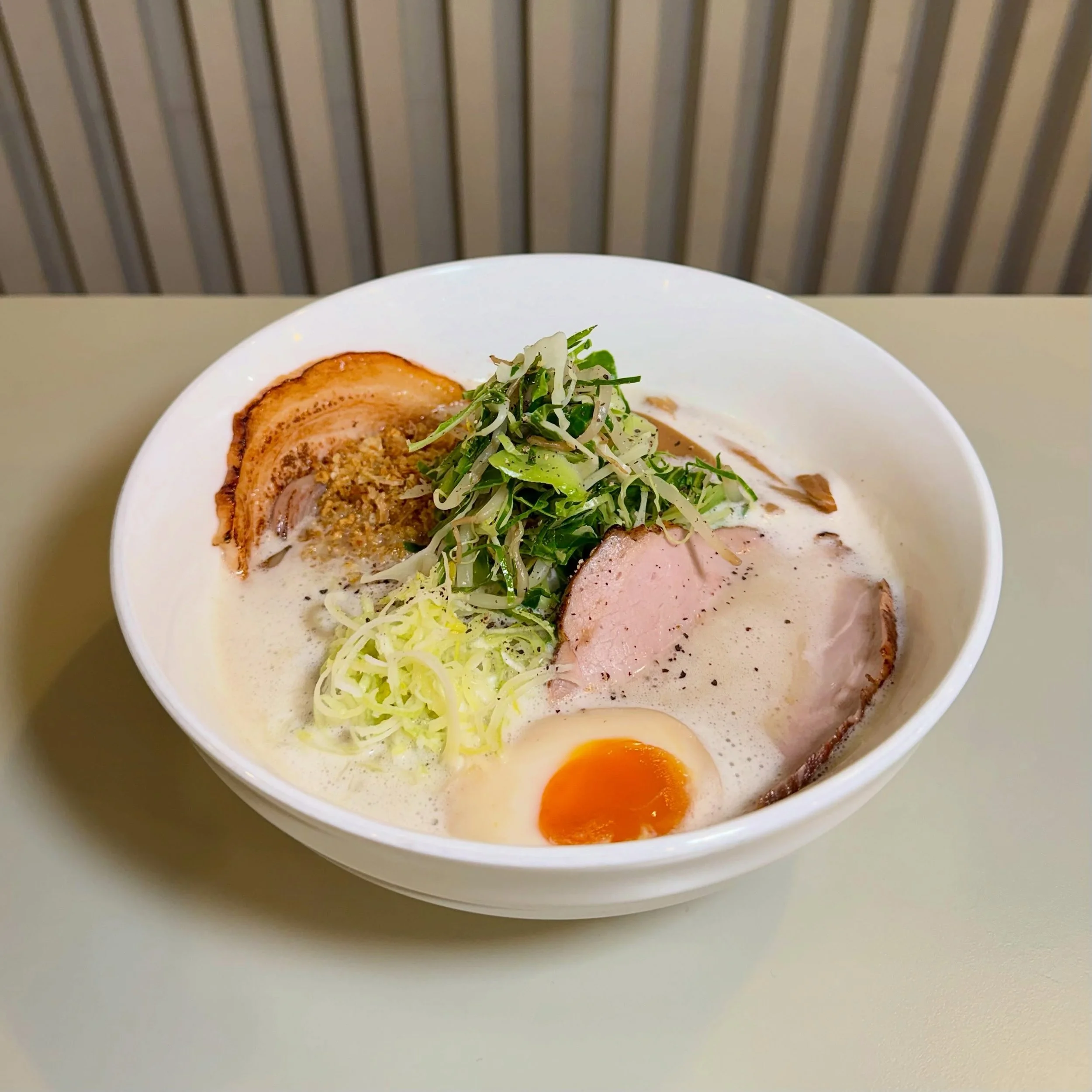 TONKOTSU

As the weather changes and the days get shorter, we start bringing back some of those autumn/winter favourites to keep you going through the colder months.

PAITAN SOUP
TRIPLE GARLIC AROMA OIL
PORK BELLY
COPPA CHASHU
STEAMED CABBAGE AND BEA