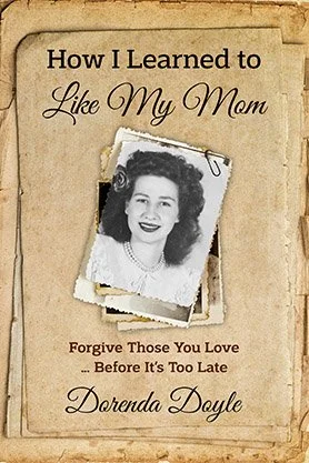 Memoir cover for “How I Learned to Like My Mom” by Dorenda Doyle, featuring a vintage sepia-toned design with an old family photograph and textured paper background.