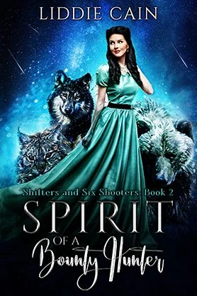 Paranormal western romance book cover for “Spirit of a Bounty Hunter” by Liddie Cain, featuring a woman in a flowing teal dress with a wolf and a large white bear.