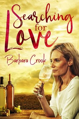 Contemporary romance book cover for “Searching for Love” by Barbara Crook, featuring a woman holding a glass of wine overlooking a sunlit vineyard.