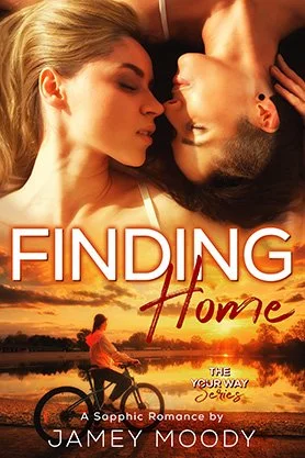 Sapphic romance book cover for “Finding Home” by Jamey Moody, featuring two women close together above a warm sunset scene with a seated figure by the water.