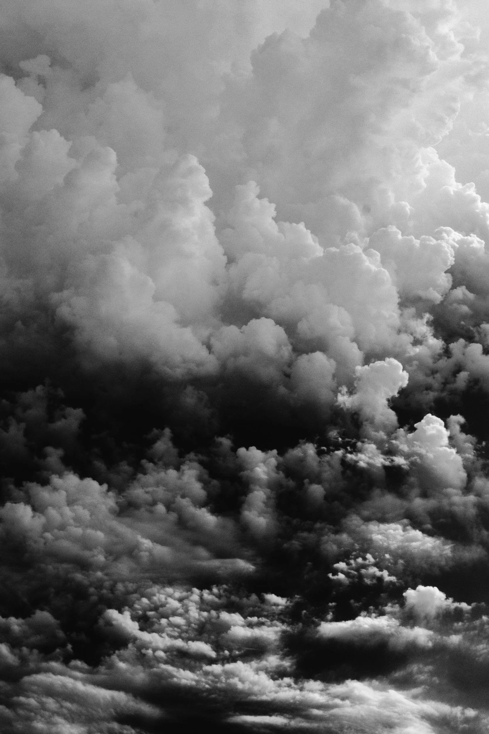 Black and white photograph of a cloudy sky with no visible land or other objects.
