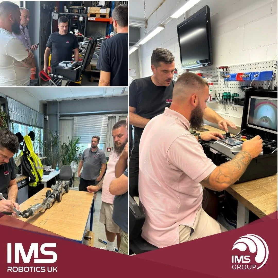 Group of men in a workshop learning about robotics and technology, with some examining mechanical parts and others working on computer screens.