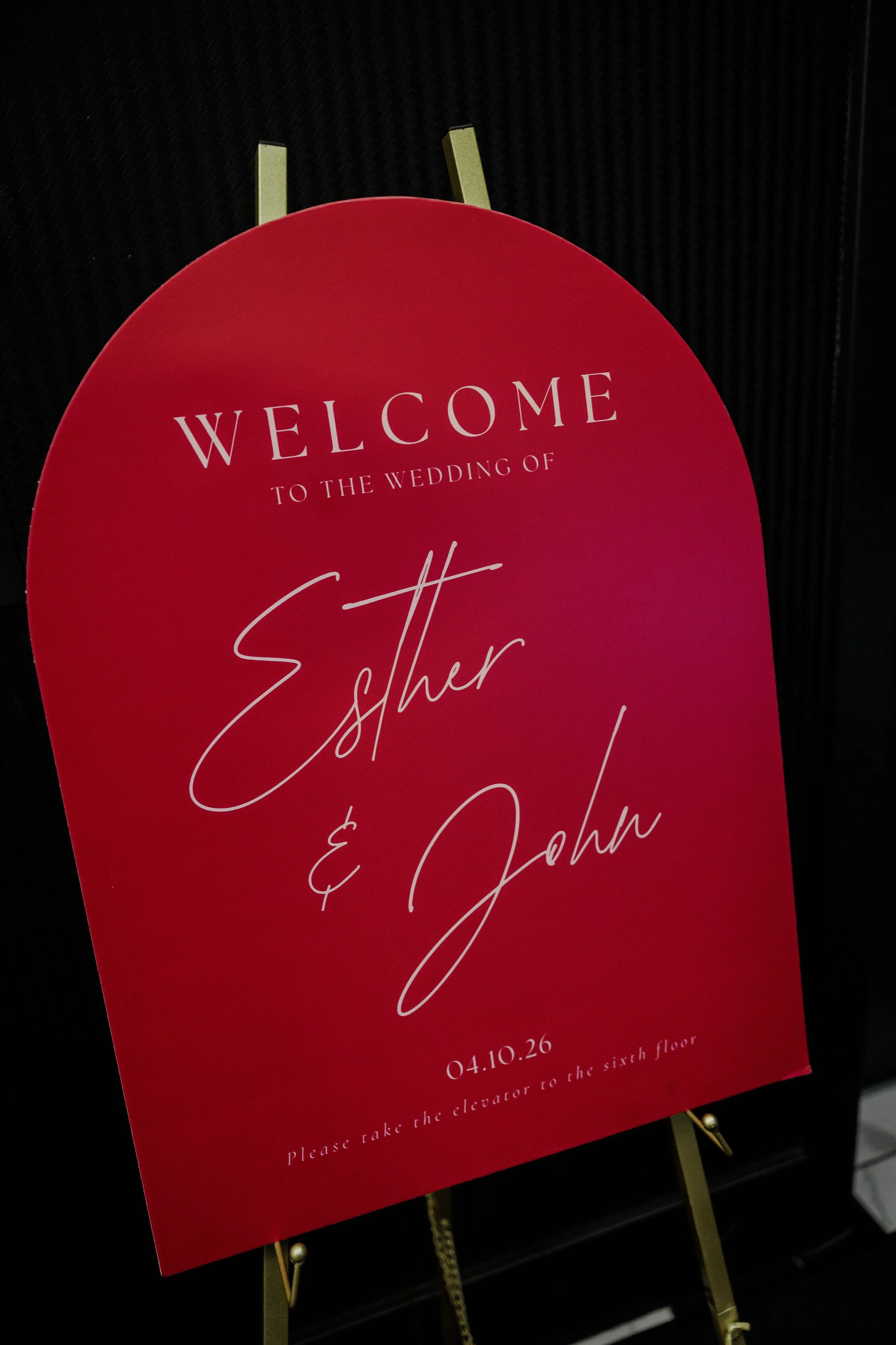 Arched wedding welcome sign on gold easel