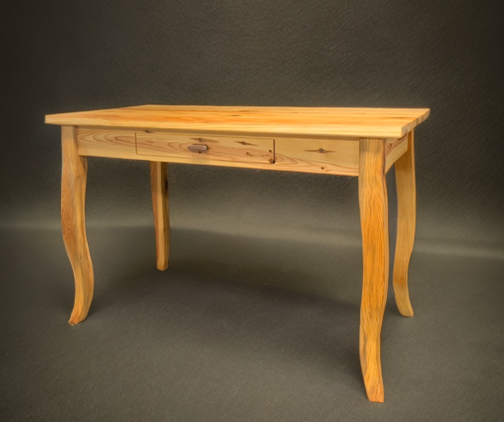 A wooden table with curved legs and a drawer in the middle, set against a dark background.