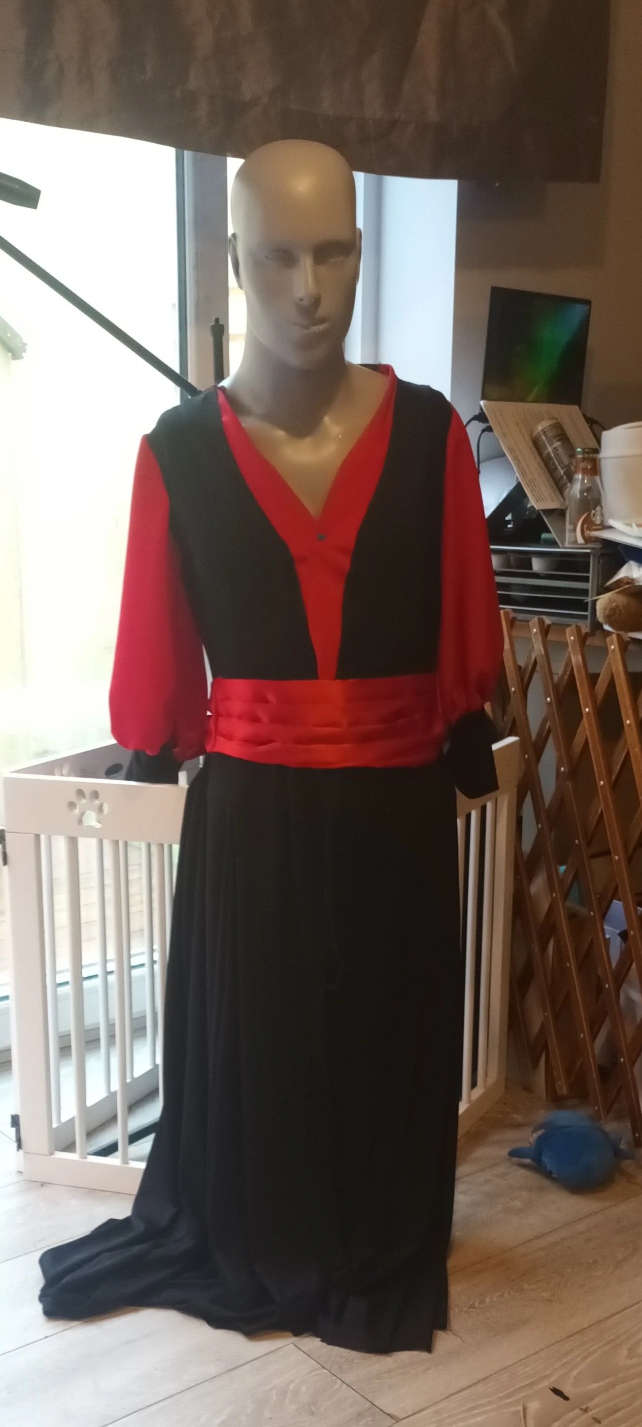 black long-sleeved dress featuring a contrasting red V-neck panel and a matching red satin sash at the waist made for a youth theatre production of Aladdin