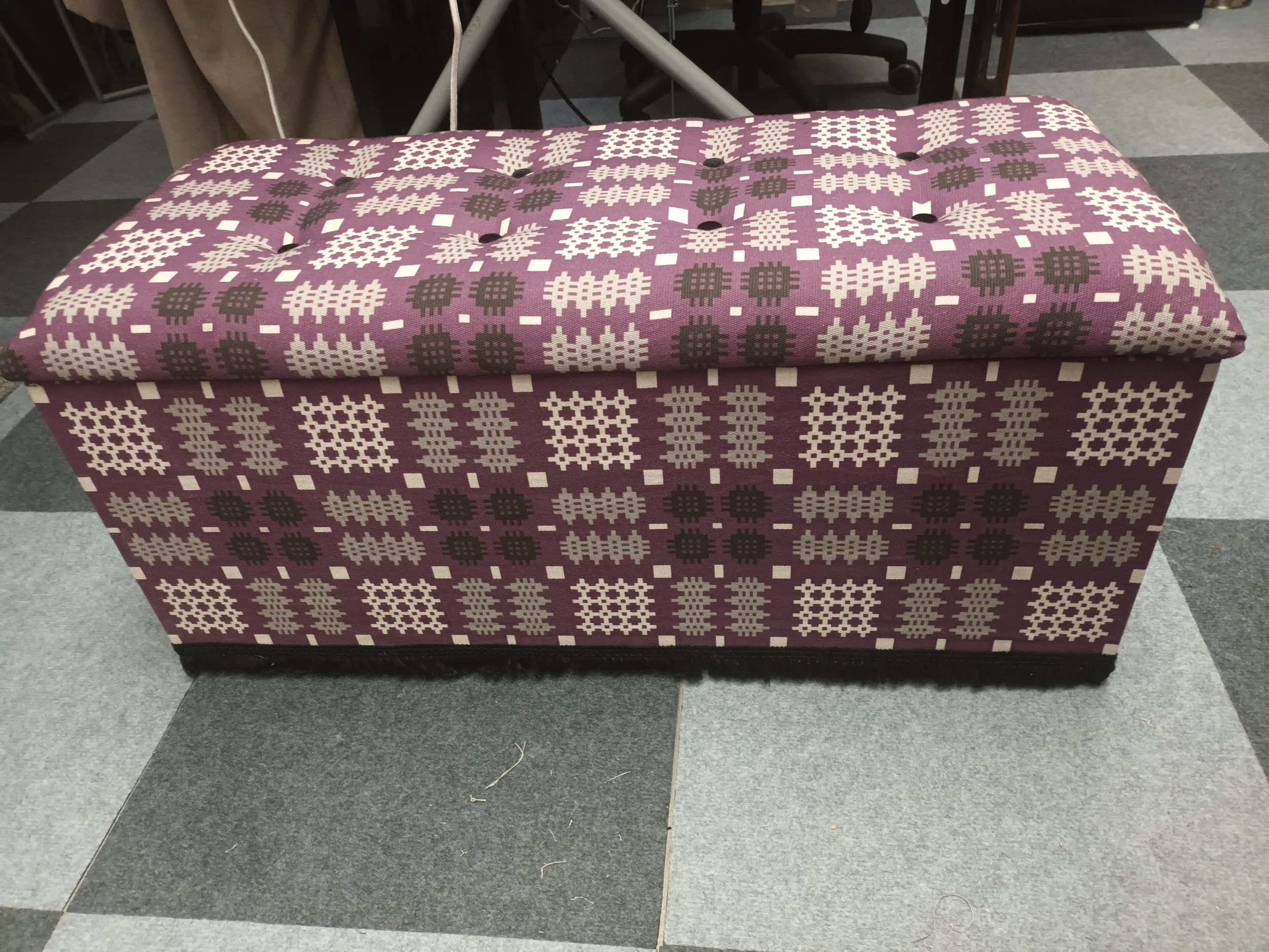 Re-upholstered ottoman in a Welsh blanket style fabric