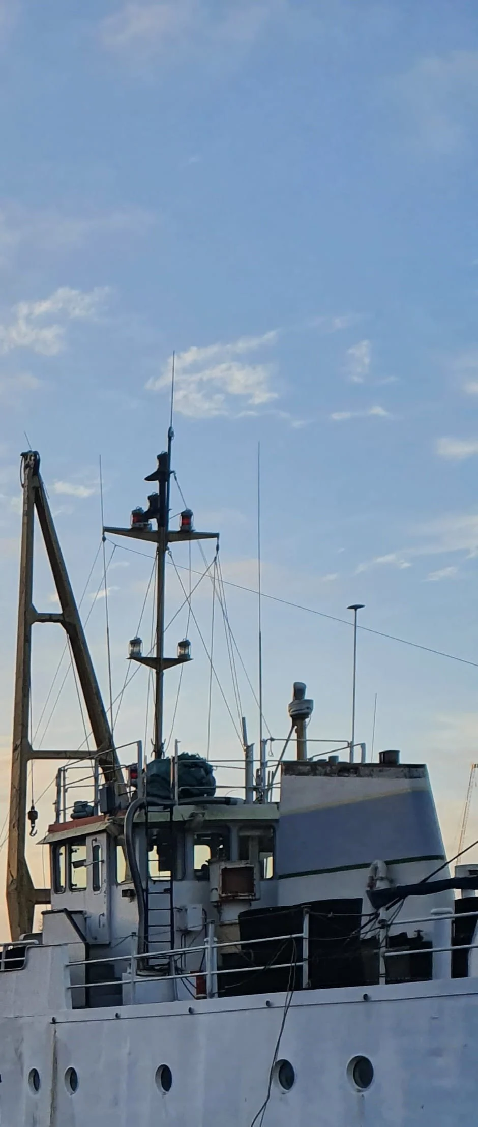 Fishing vessel moored at a Marina under a clear sky. Imagery from The Log. AbeySea's maritime  case study stories