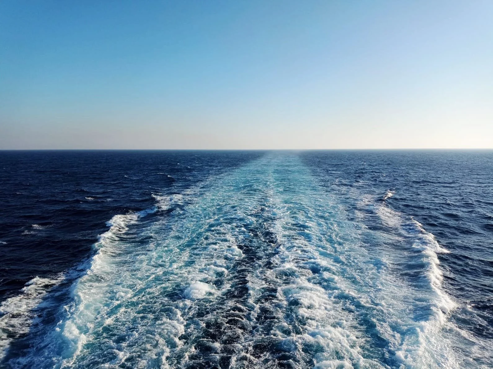 Wake trailing a vessel crossing the open ocean. Bristol based consultancy exploring ESG, storytelling and Social & Governance