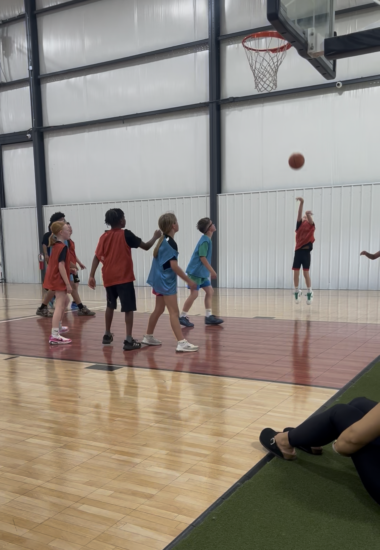 Children developing basketball skills during a Gary Family Foundation youth sports program.