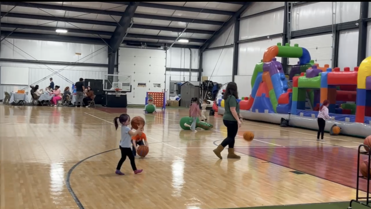 Children participating in a Gary Family Foundation youth basketball program and community event.