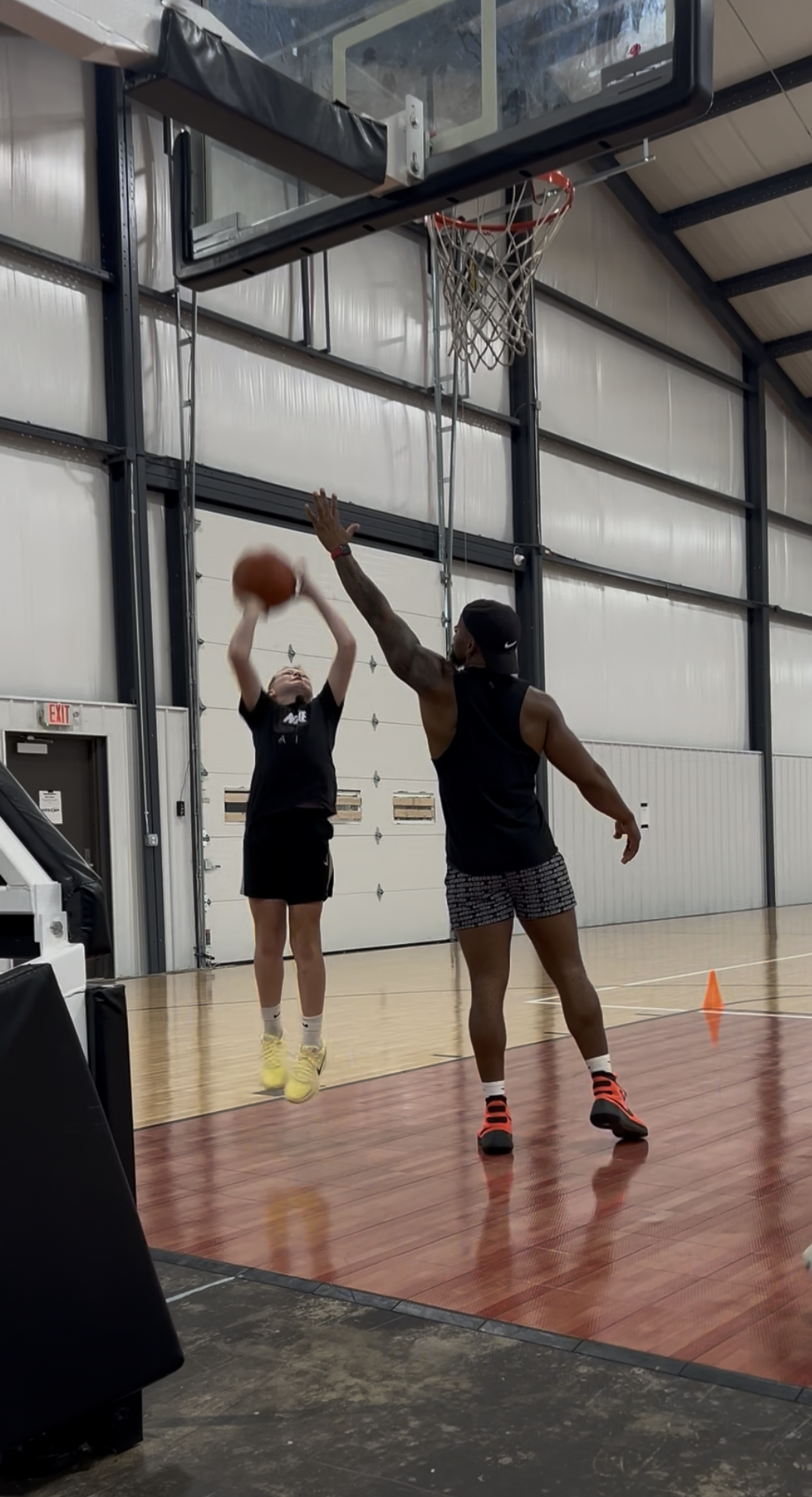 Youth participant practicing basketball skills with a coach during a Gary Family Foundation program.