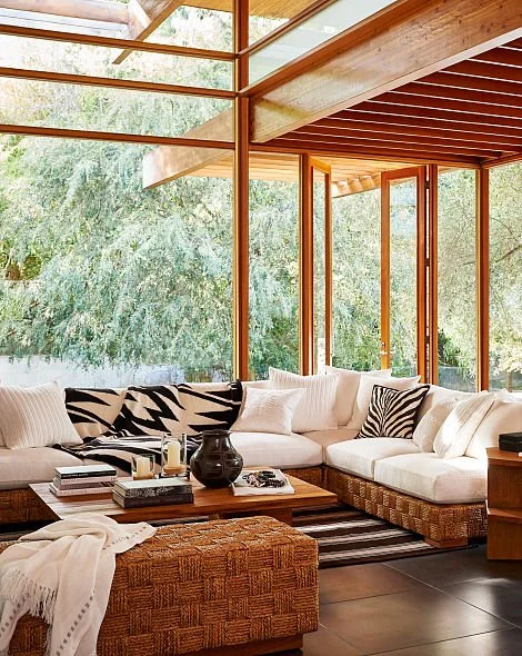 Modern living room with a white sectional and zebra-pattern hair-on-calf pillow.