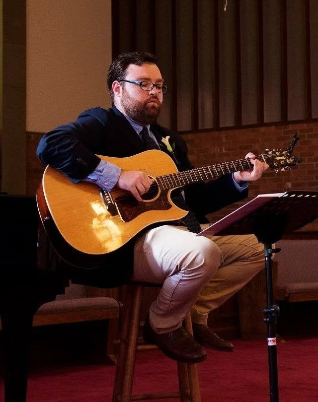 Jesse Wiener playing acoustic guitar