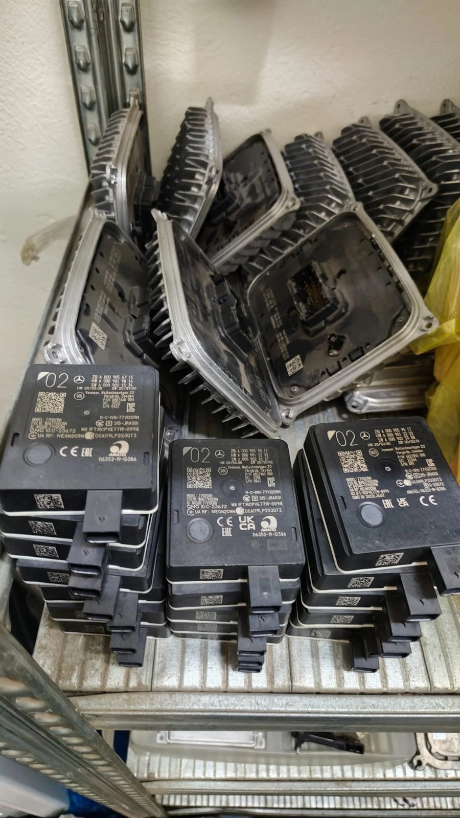 Stacked electronic control modules with circuit boards in metal casings.