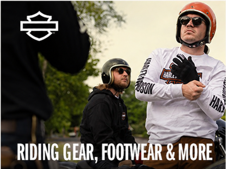Two men wearing Harley-Davidson gear and helmets, standing next to motorcycles outdoors, advertising riding gear, footwear, and more with a 'Shop Now' button.