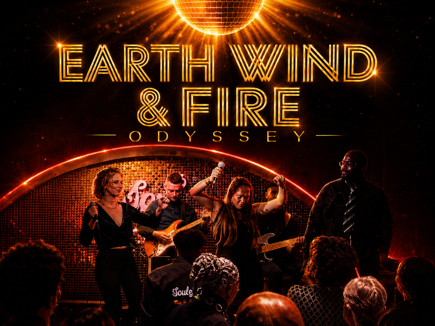 A live musical performance on stage with a band, featuring a female singer holding a microphone, backup singers, and musicians playing guitars, under bright stage lights and a large neon sign reading 'Earth Wind & Fire Odyssey'.