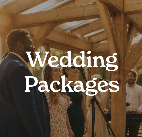 People attending a wedding event inside a rustic wooden venue.