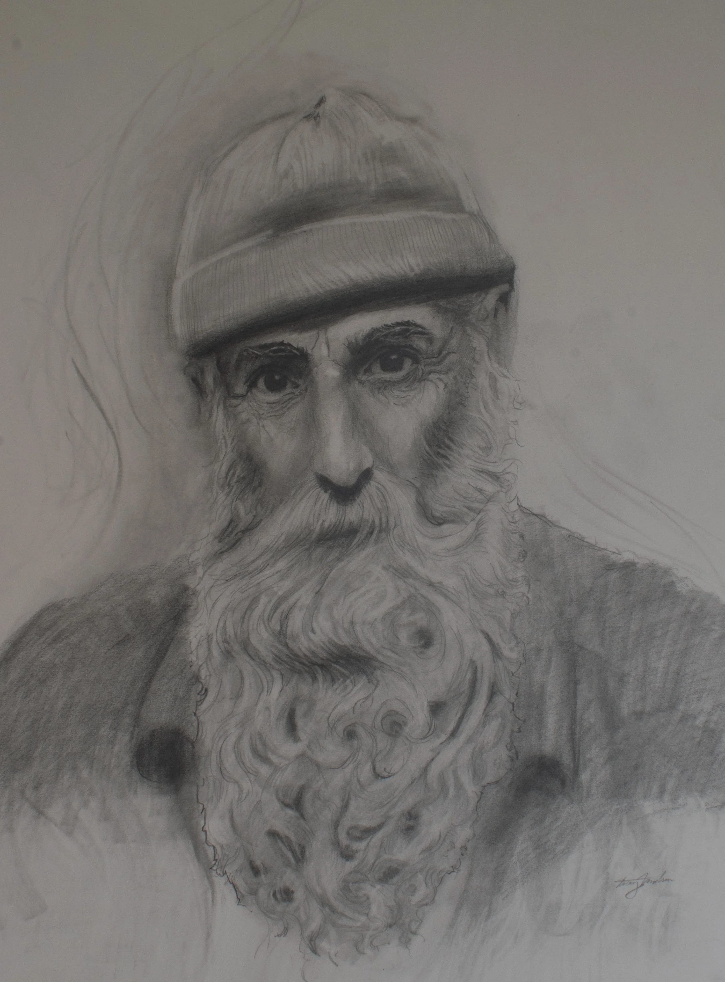 A detailed black and white pencil drawing of an elderly man with a long, flowing beard and deep-set eyes, wearing a beanie cap.