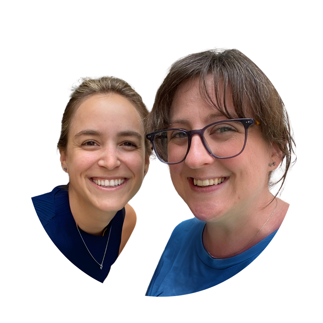 Close-up of two smiling women with a black background, heart-shaped frame around their faces, one wearing a blue shirt with sunglasses and the other in a navy top with a necklace.