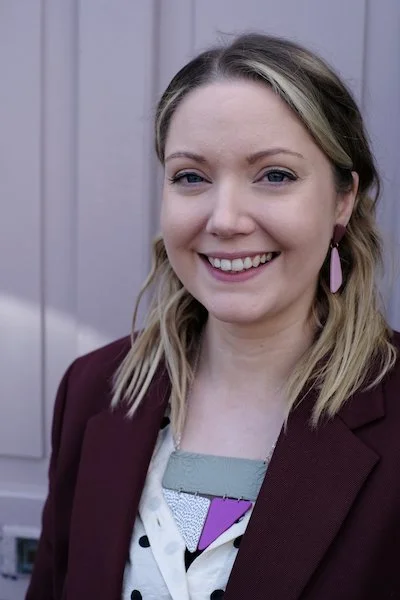 Jewellery Designer Sarah McEvoy wearing pink earrings.