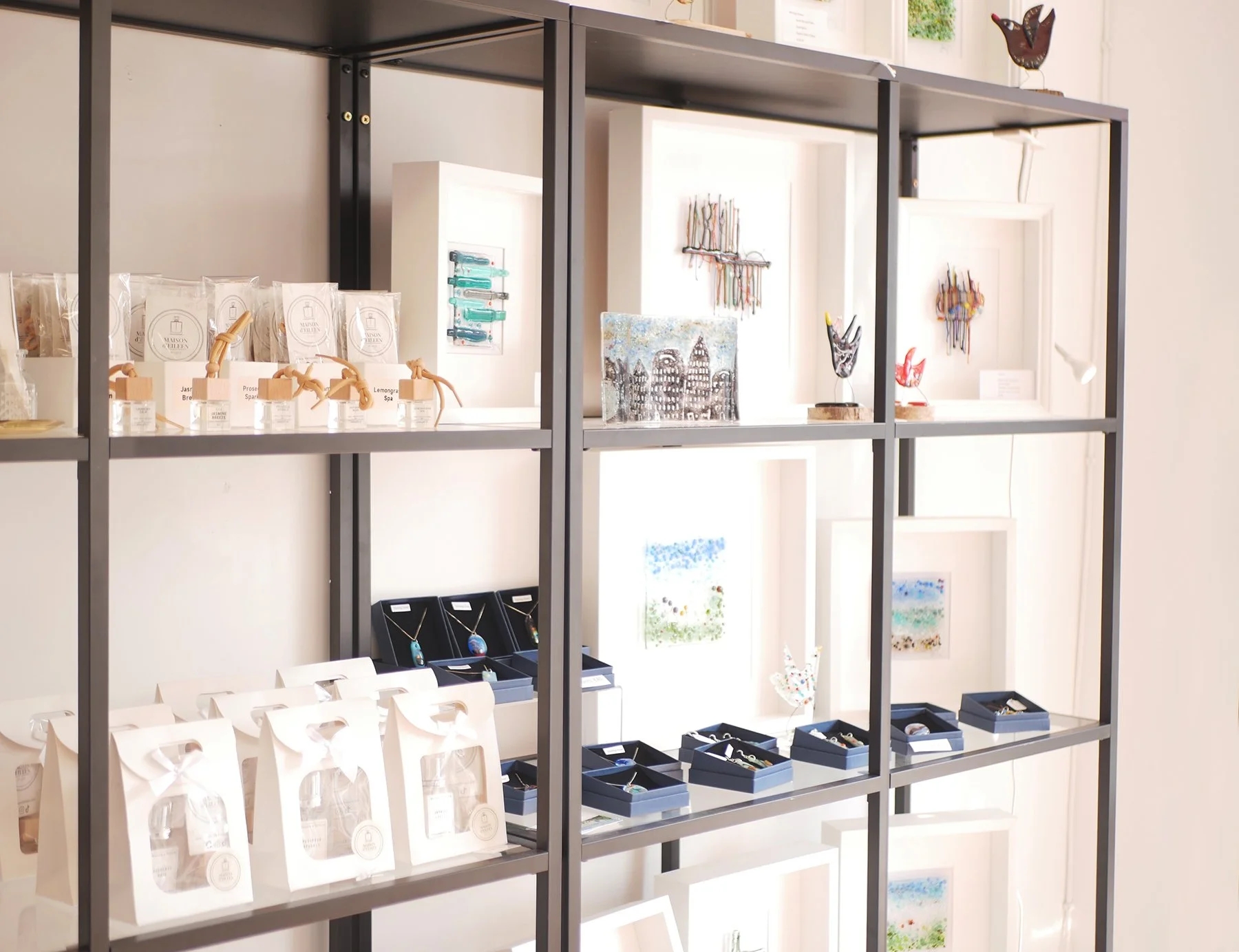 Gather gift shop shelving display with room spray and fused glass art