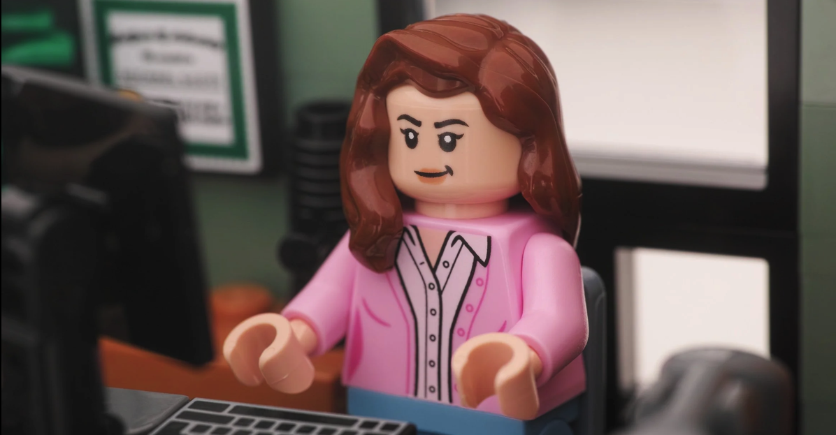 A female lego office worker looking at a computer screen