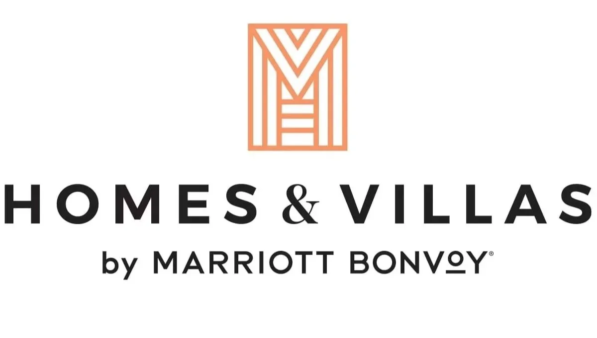 Logo for Homes & Villas by Marriott Bonvoy with an abstract orange graphic above the text.