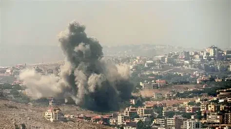 Explosion with a large plume of black smoke over a cityscape.