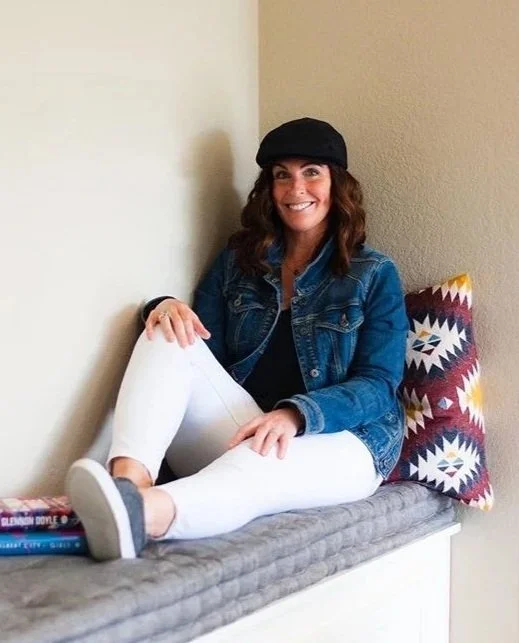 Photo of a woman sitting on a handmade cushion made by Max Holden.