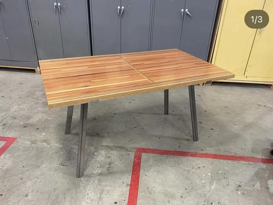 Photo of a wooden table with steel legs built by Max Holden