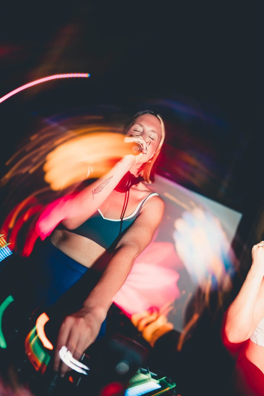Rachel Molenda wearing blue cheerleading uniform performing and MC-ing at REUNION Dance party event