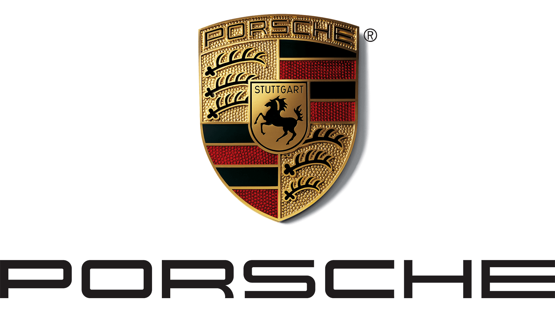 Close-up of the Porsche badge with gold and red detailing on a black background.