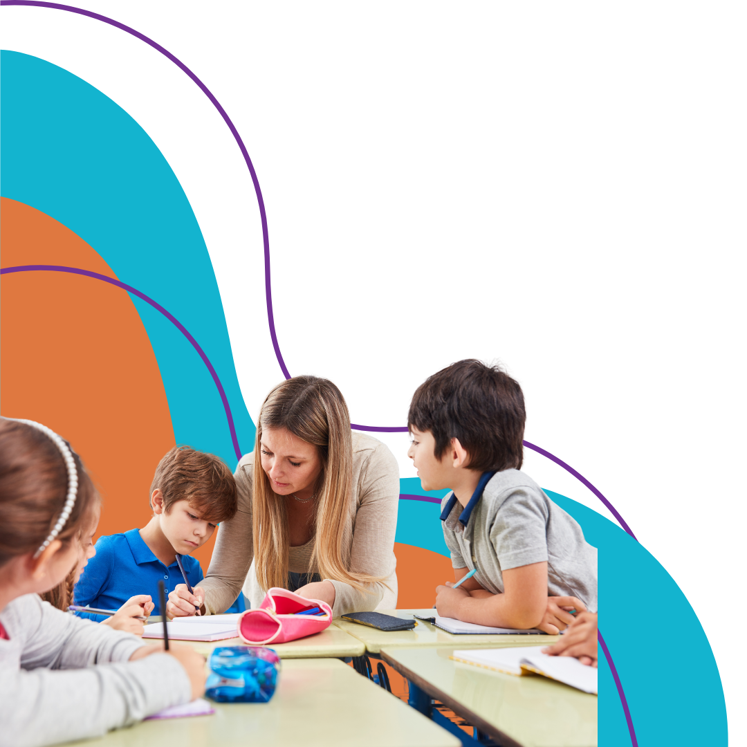 A teacher working with four young students at a classroom table.