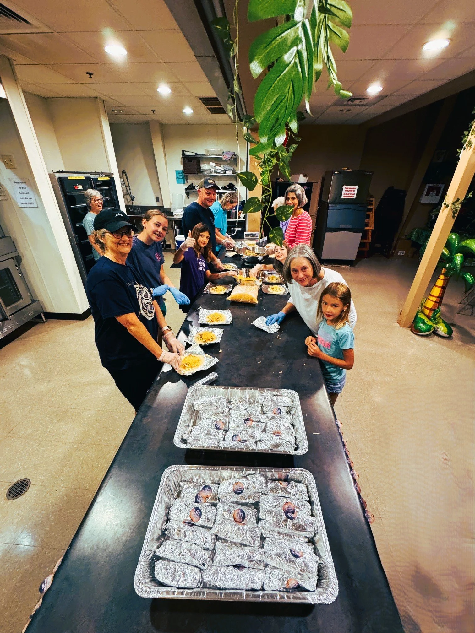 NBCOC volunteers preparing breakfast tacos for First Footing guests.