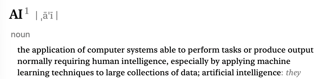 A computer screen showing a dictionary definition of artificial intelligence, explaining it as the ability of systems to perform tasks that normally require human intelligence using machine learning.
