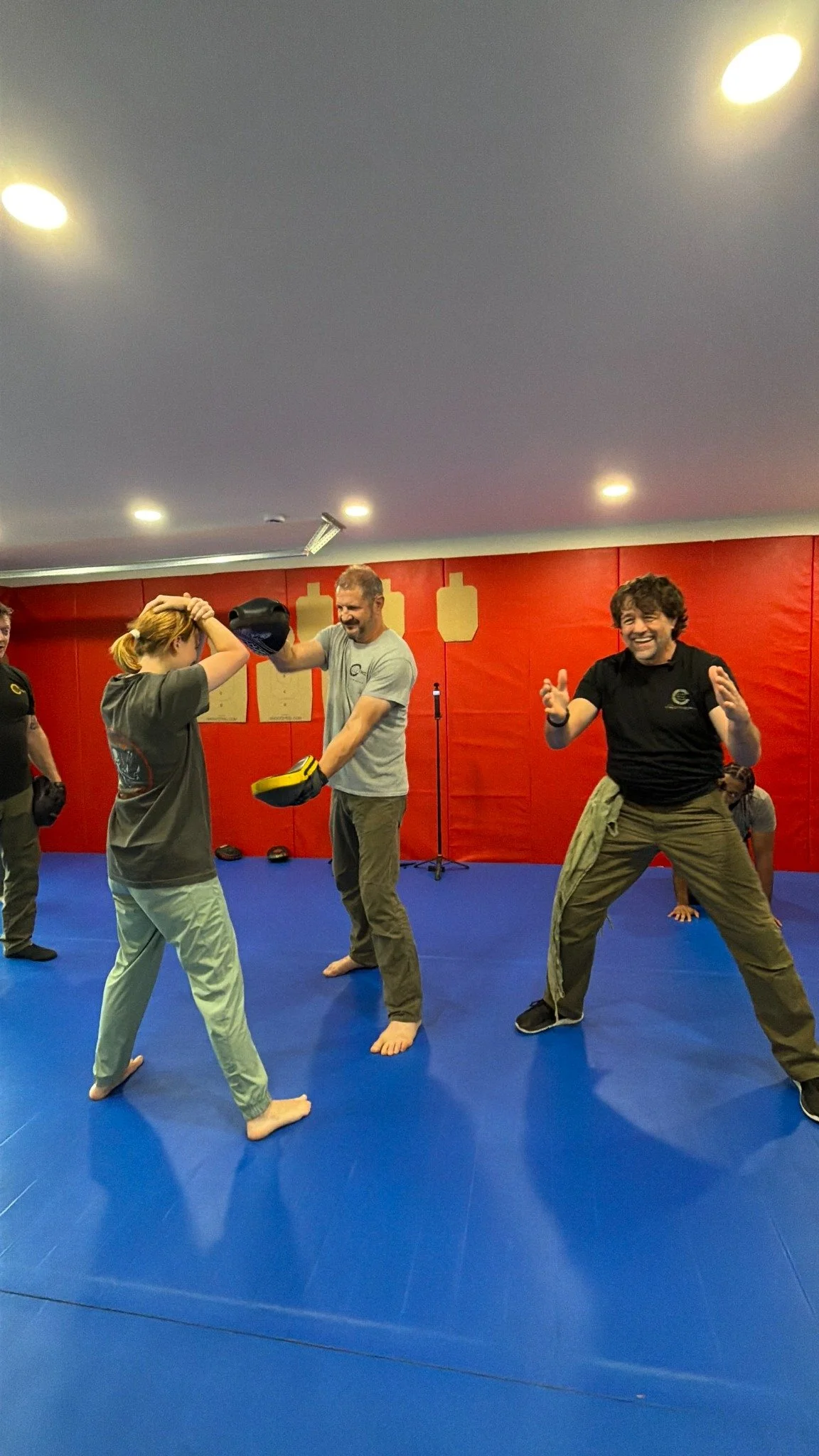Kraken Combatives students practicing pad drills during hands-on training.